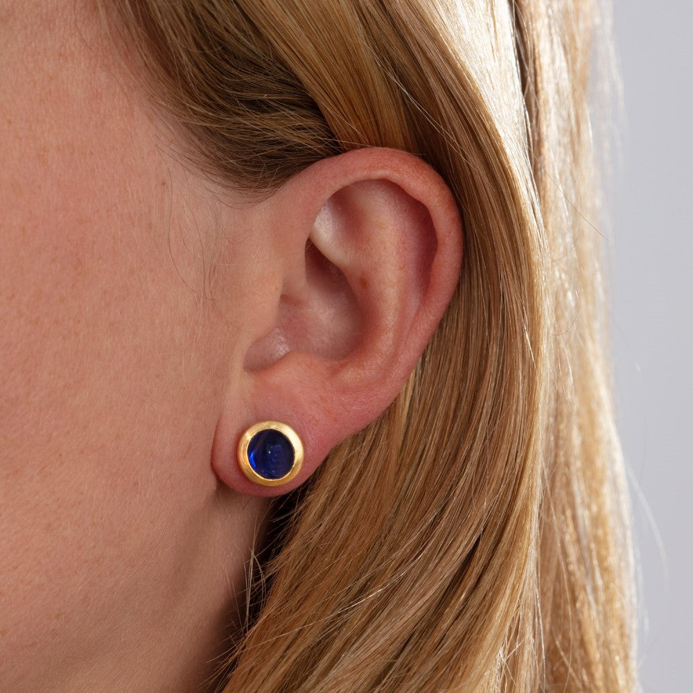 Model pictured wearing small blue sapphire studs 