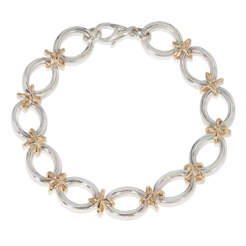 Silver bracelet with gold links pictured on a white background
