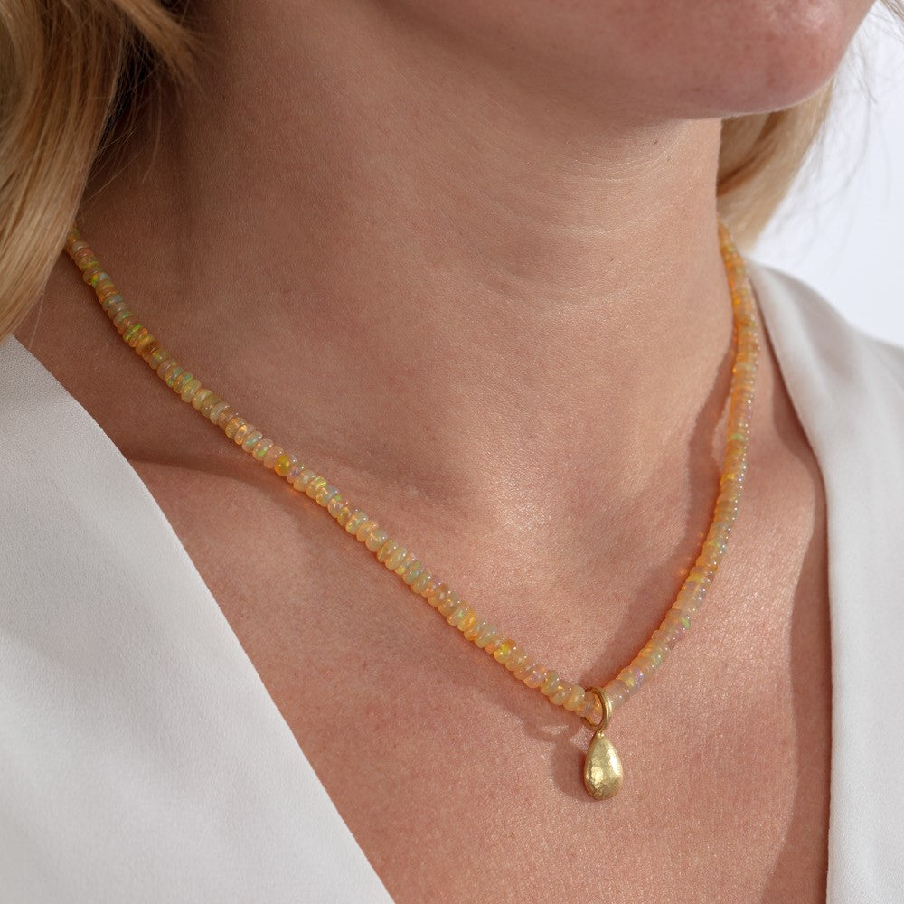 Model pictured wearing yellow opal bead necklace