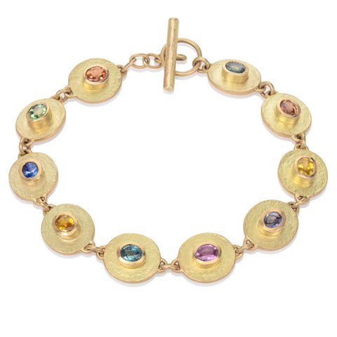Sapphire and yellow gold bracelet on a white background