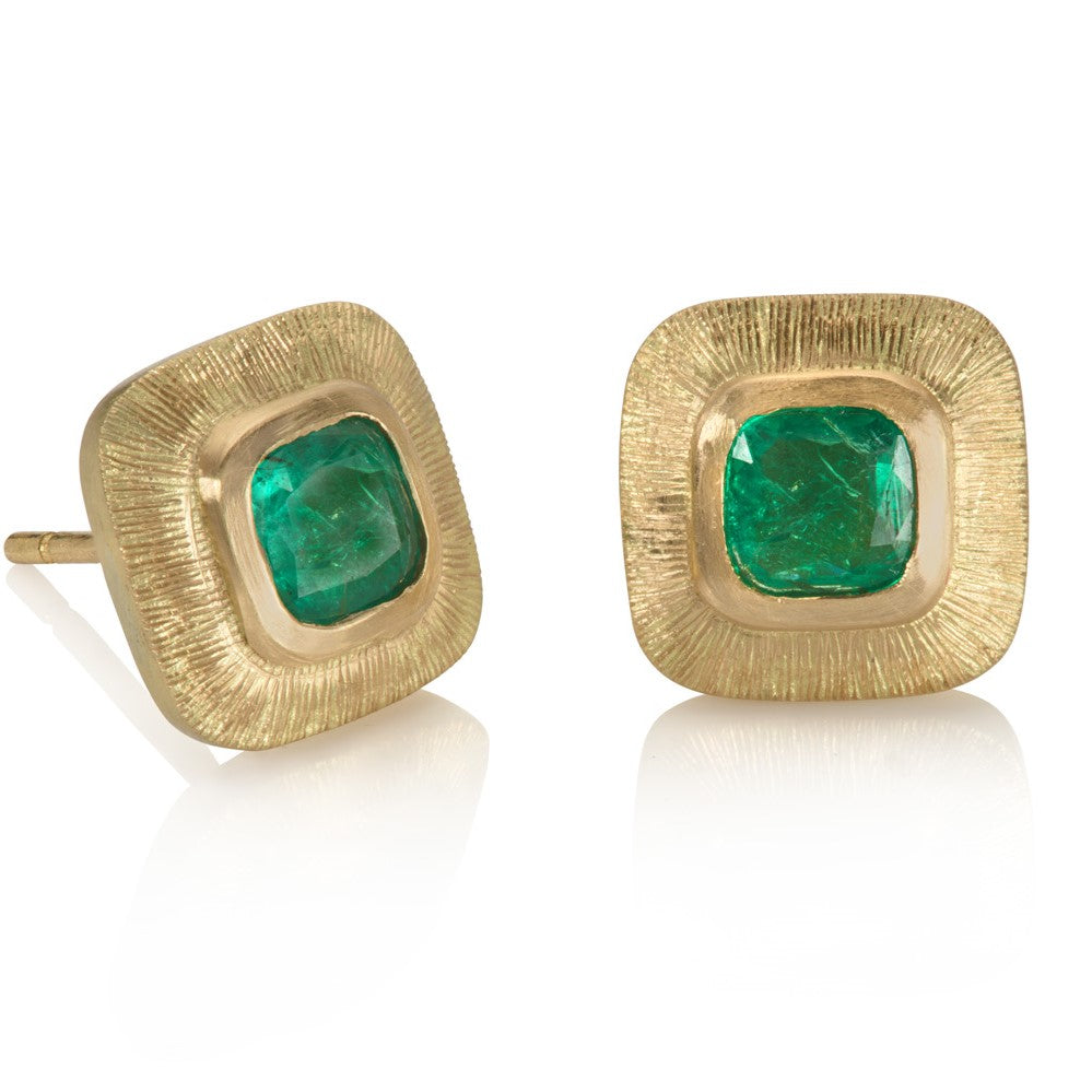 Green emerald engraved gold stud earrings on white background