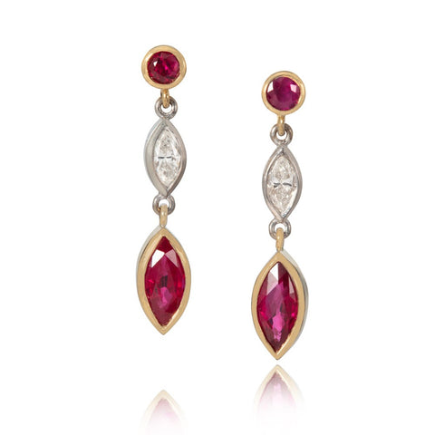 Ruby and diamond drop earrings on white background