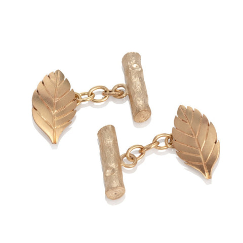 14ct yellow gold leaf cufflinks on a white background