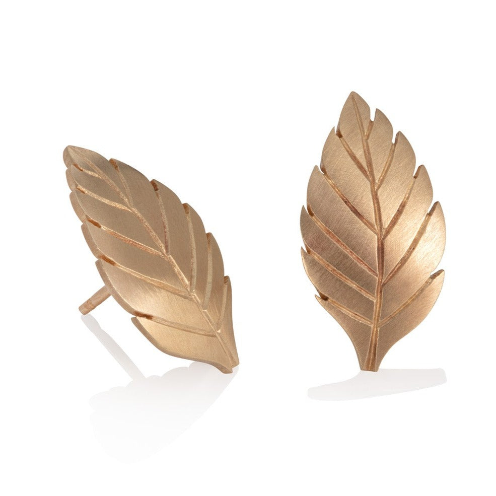 gold leaf earrings shown on a white background