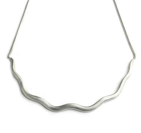 Silver necklace with smooth wave shaped portion, hung on silver chain