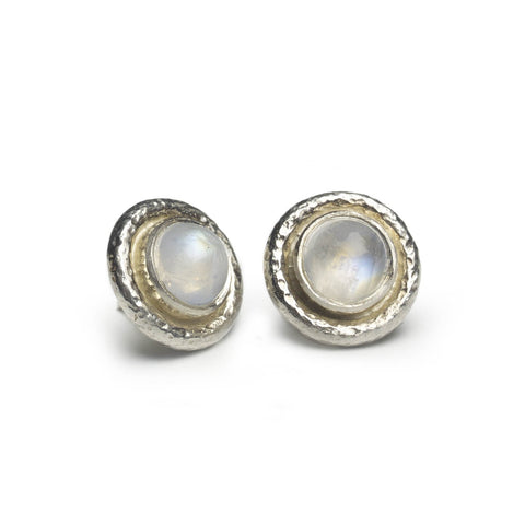 Silver stud earrings set with moonstone shown on a white background