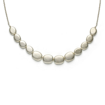 Silver necklace, comprising a chain, attached to twelve matte finish pebble-style silver rondels