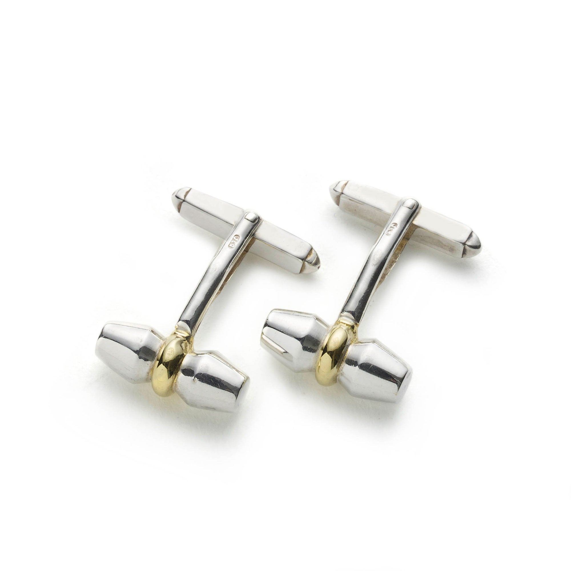 Silver and yellow gold toggle cufflinks on white background