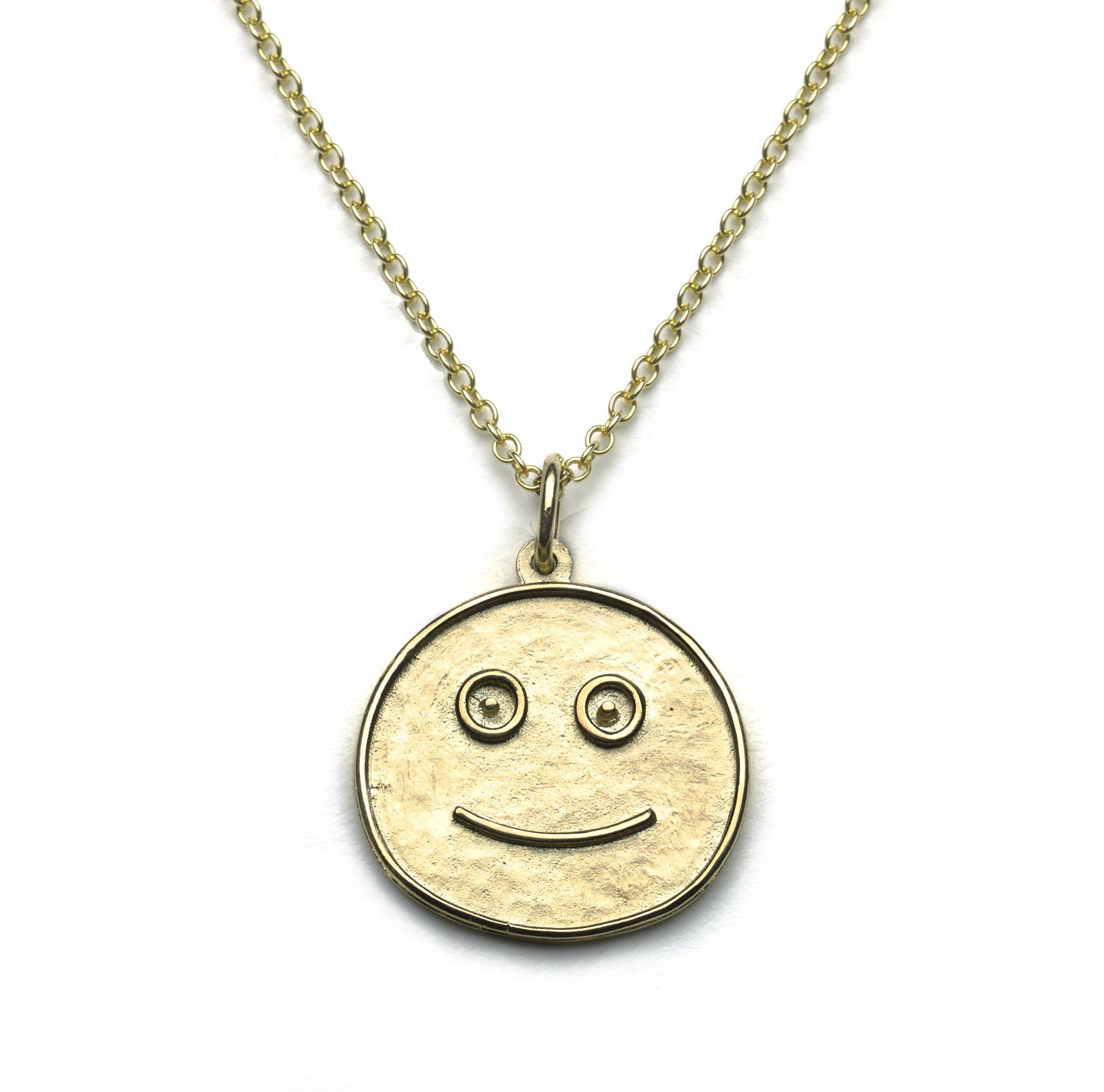 Yellow gold smiley face pendant on white background