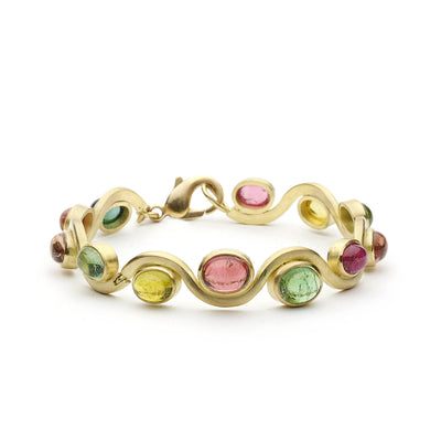 Wavy 18ct yellow gold bracelet set with tourmaline cabochons on white background